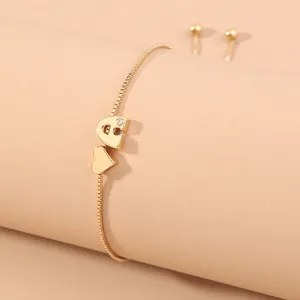 Gold adjustable letter charm bracelet detail, minimalist box chain with heart slider.