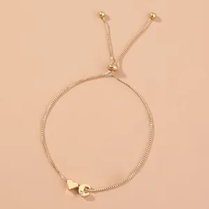 Gold adjustable box chain bracelet featuring a heart charm and crystal letter C pendant.