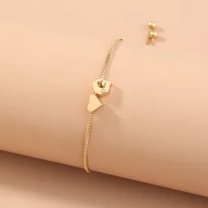Elegant gold box chain bracelet featuring a sparkling initial letter and sweet heart charm.