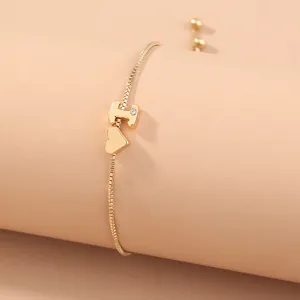 Exquisite gold box chain bracelet featuring an elegant letter pendant and cute heart charm.
