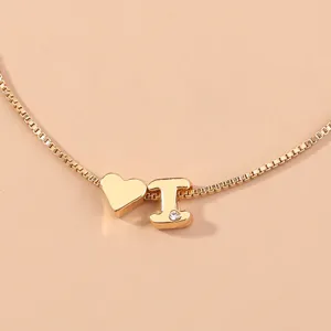 Gold color box chain necklace featuring a cute heart charm and letter pendant with sparkling crystal.