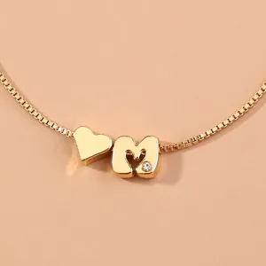 Gold-plated box chain bracelet detailed with a cute heart charm and letter M pendant.