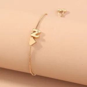 Minimalist gold box chain slider bracelet featuring an initial letter N and heart charm.