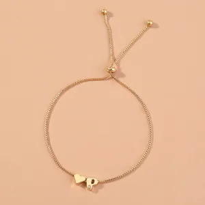 Close-up detail of a gold adjustable box chain bracelet featuring heart and letter P charms.