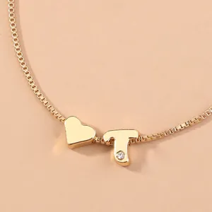 Gold box chain detail with heart and letter T rhinestone pendant for adjustable bracelet.