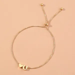Gold box chain adjustable bracelet with heart and letter U charm for women daily wear.