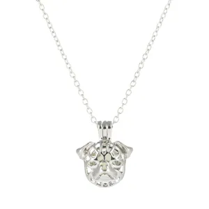 Detailed view of the luminous dog pendant necklace with hollow cage design, glowing in dark.