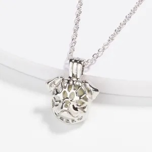 Close-up detail of the creative hollow pug dog glowing bead pendant necklace in silver.