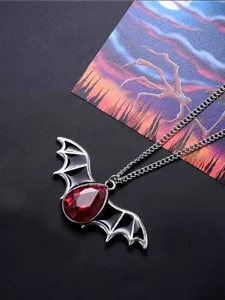 Gothic bat wing necklace with red gemstone and black enamel for punk Halloween gifts.