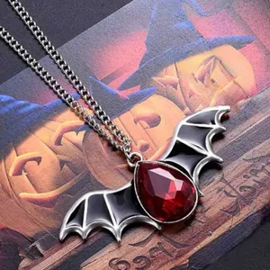 Gothic vampire bat wing necklace with red teardrop gemstone, dark punk jewelry gift for women.