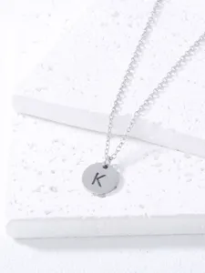 Closeup of the stainless steel letter K pendant necklace detail showcasing the shiny finish.