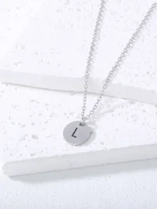 Detailed shot of stainless steel letter L pendant necklace showcasing fine metal chain texture.