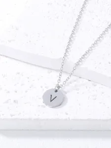 Detailed view of minimalist silver stainless steel letter V pendant necklace closeup.