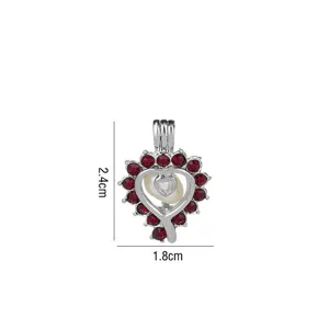 Ciondolo a gabbia cuore argentato accessorio gioielli DIY con pietre rosse e perla.