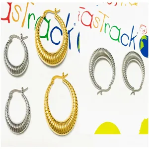 Gold and silver ribbed hoop earrings crafted from stainless steel for a chic, stylish look.