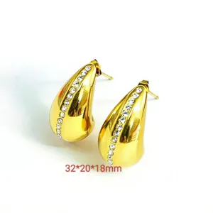 Detailed shot of the elegant teardrop stud earrings with crystal pave and shiny gold finish.