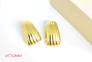 Close-up of geometric trapezoid striped earrings detail, 18k gold plated stainless steel.