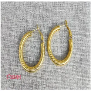 Detail view of 18K gold plated stainless steel ribbed hoop earrings measuring 5x30mm.