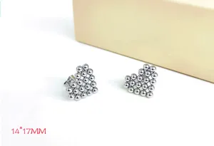 Detailed shot of stainless steel bead heart earrings, showing the delicate ball texture clearly.