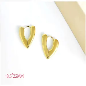 Detailed view of gold plated stainless steel geometric heart earrings, minimalist jewelry.