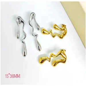 Detail shot of abstract irregular metal earrings in dual gold and silver finish style.