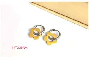 Stainless steel flower hoop earrings detail view, golden floral charm, size 14x22mm.