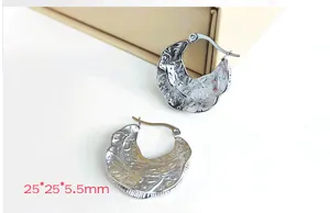 Stainless steel hoop earrings detail showcasing irregular textured design, retro style.