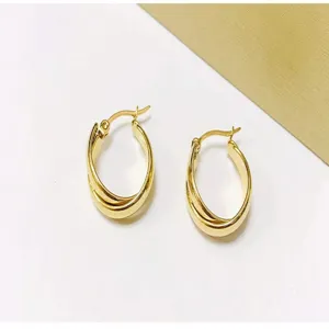 Close-up detail view of the elegant interlocking gold hoop earrings, exquisite design.