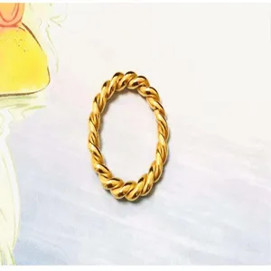 Minimalist 18k gold stainless steel twist rope ring, trendy hip hop fashion jewelry detail.