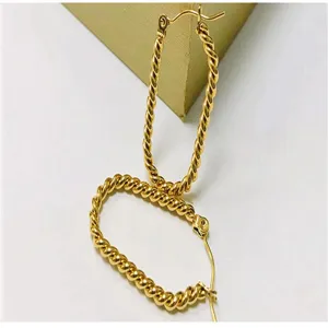 Detail shot of minimalist 18K gold plated twisted rope hoop earrings, stylish oval design.