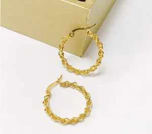 Detailed view of 18K gold plated twisted chain hoop earrings with elegant woven design.