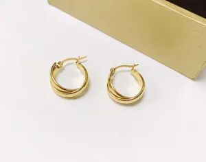 Close-up detail shot of the elegant multi-strand interlocking gold hoop earrings showcase.