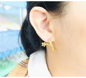 Gold star hoop earrings close up view, elegant twist metal design for daily wear fashion jewelry