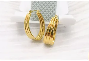 Detail view of wide gold stainless steel multi-band hoop earrings featuring a modern design.