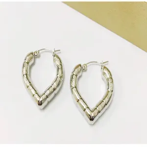 Trendy heart-shaped bamboo textured hoop earrings in silver stainless steel finish.