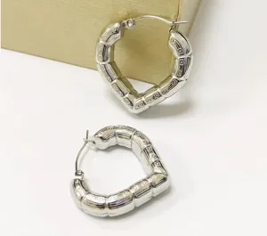 Detail view of silver heart hoop earrings with retro bamboo pattern, stainless steel.