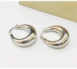 Thickened 10mm crescent hoop earrings in hollow shrimp pattern design, polished silver tone finish.