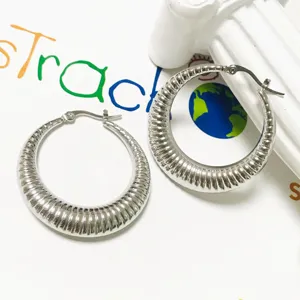 Silver stainless steel chunky ribbed hoop earrings, trendy crescent design for women fashion.
