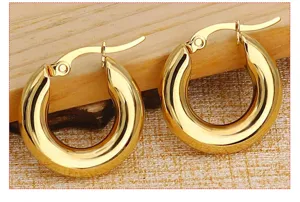 Detailed shot of thick gold hoop earrings, showcasing the polished finish and sturdy clasp.