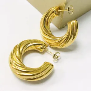 Chunky gold twisted hoop earrings for women, stylish French fashion metallic hoops.