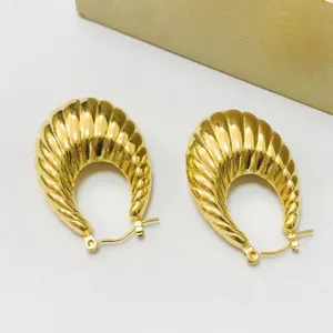 Chic thick gold plated croissant hoop earrings, modern minimalist statement jewelry for women.