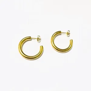 Trendy thick gold hoop earrings, classic C-shaped design, stylish and versatile jewelry.