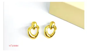 Gold molten heart earrings detail shot showcasing the unique geometric shape and polished finish.