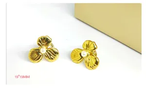 Gold-plated camellia flower pearl stud earrings, elegant and luxury design for women.