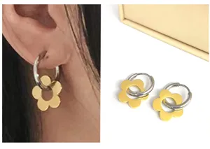 Trendy stainless steel hoop earrings with gold flower pendant, elegant daily jewelry accessory.