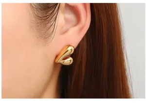 Chic 18k gold plated hollow heart-shaped stud earrings, elegant puffy ear detail close-up