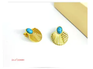 Close-up of vintage gold stainless steel shell earrings with blue turquoise stone.