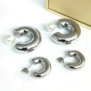 Chunky silver C-shape hoop earrings with pearl accents, minimalist fashion jewelry style.