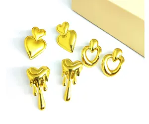 Close-up details of trendy stainless steel gold-plated lava and double heart earrings style.