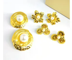 Detailed view of luxury gold pearl earrings set, featuring elegant camellia flower and disc studs.